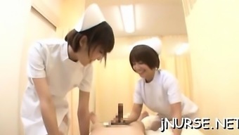 Breathtaking japanese nurse plays with toys on a large rod
