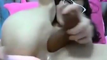 Nerdy camgirl from China dildos her two fuck holes