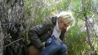 Mature caught pissing outdoors next to tree