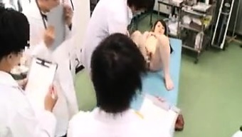 Slim Oriental cutie has a group of doctors examining her ha