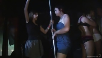 Wild party girls dance on a stripper pole and get naked in public