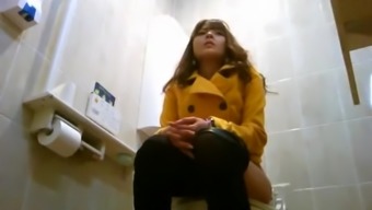 Asian women taking a leak in public toilet
