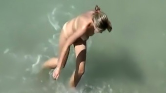 Nudist couple fucks in water