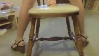 Riding a huge dildo on the chair