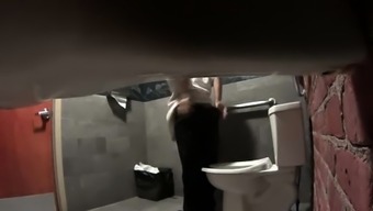 Voyeur spying on a lovely amateur brunette in the toilet