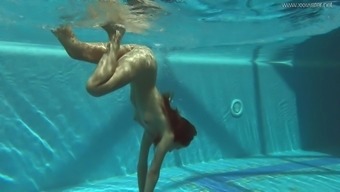 Skinny Russian girl skinny dipping in an indoor pool