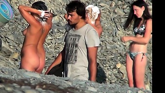 Voyeur video of a couple having intense sex at the beach