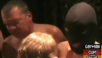 Masked gay men engage in a close-up orgy with slingshot action and facial cumshots